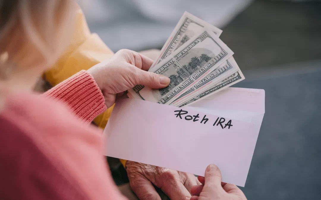 elderly couple putting money into an envelope labeled ROTH IRA