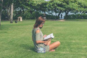 Woman sitting in the park researching debt inheritance